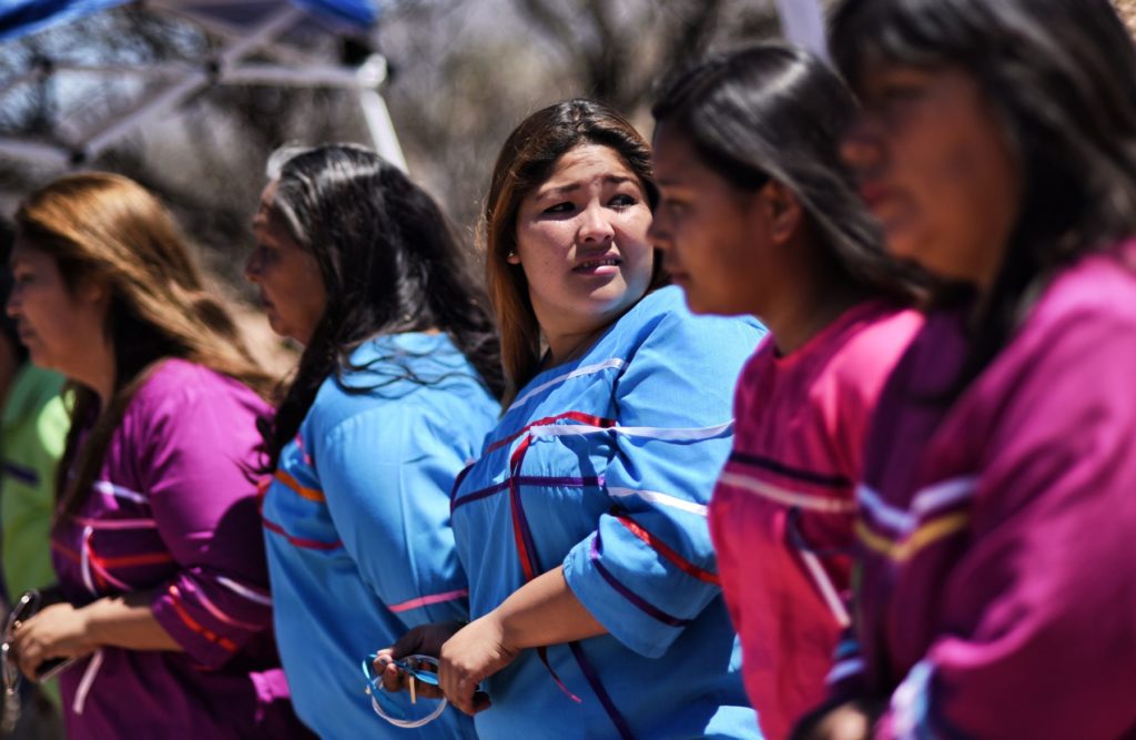 Indigenous people from the Tohono O'odham community dance and sing to protest against US President Donald Trump's intention to build a new wall in the border between Mexico and United States, on March 25, 2017, in the Altar desert, in Sonora, in the border with Arizona, northern Mexico. Photo: Pedro Pardo/AFP via Getty Images.