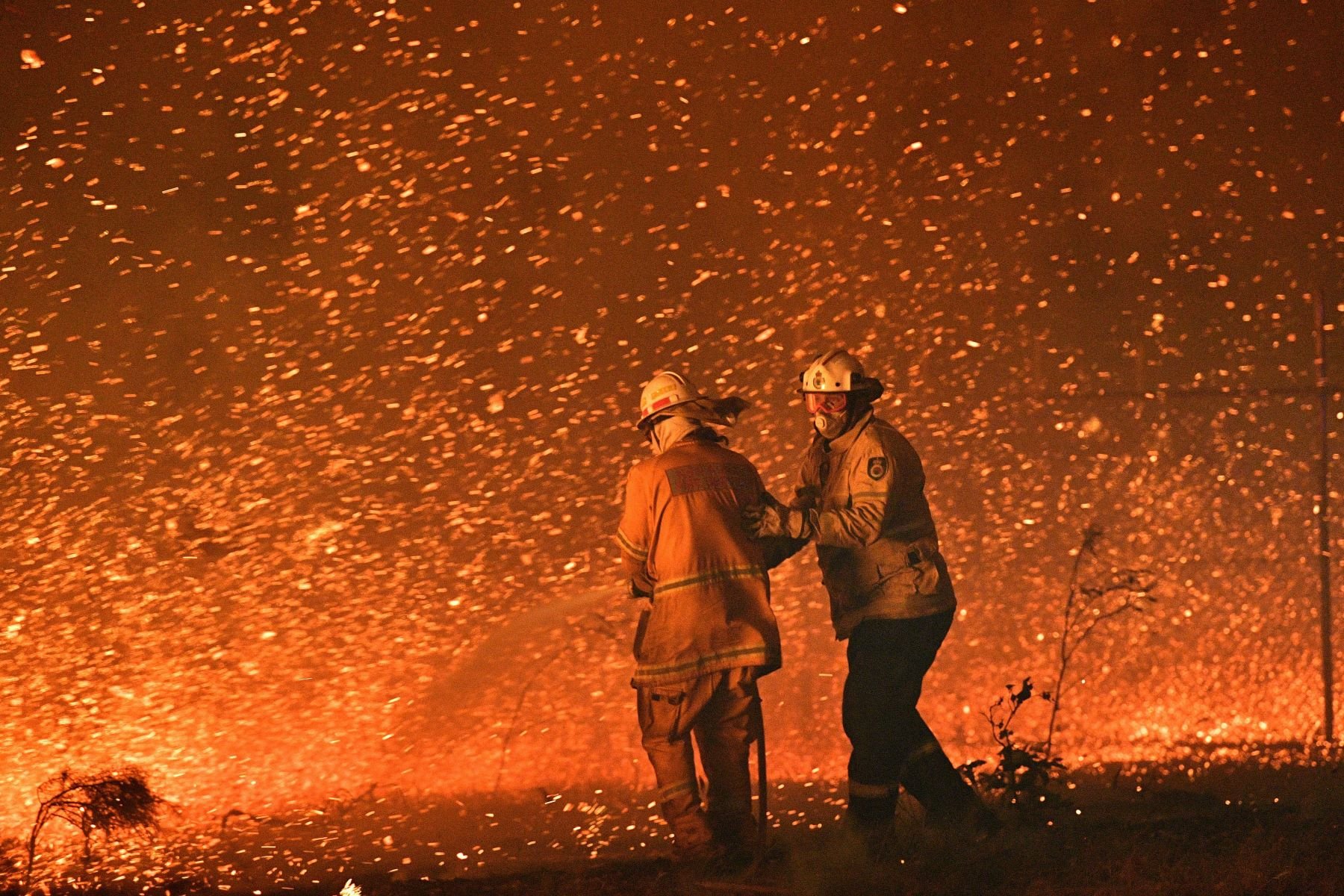 Firefighters struggling against the strong wind during the brushfires in the Australian state of New South Wales on December 31, 2019. Photo by Saeed Khan/AFP via Getty Images.