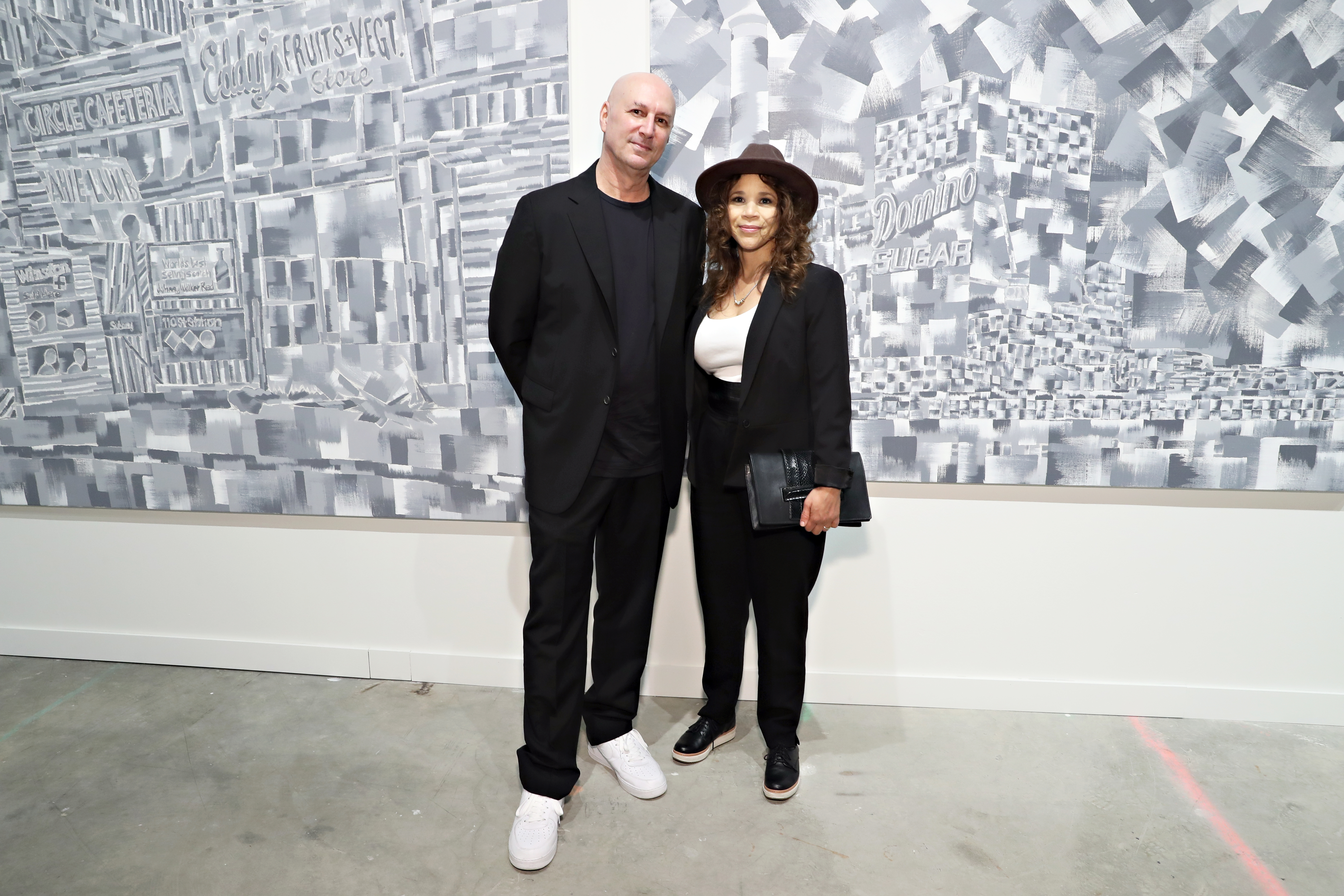 Eric Haze and Rosie Perez with his work at "Beyond the Streets." Photo by Cindy Ord/Getty Images for BEYOND THE STREETS.