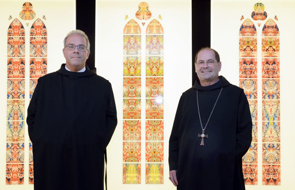 Abbot Mauritius Chorio, right, and Wendelinus Naumann present the window designs of the world-famous artist Gerhard Richter at the Benedictine Monastery in Tholey. Photo: Harald Tittel/picture alliance via Getty Images.