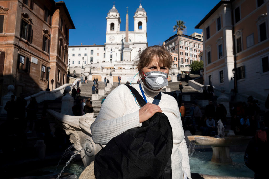 Tourists wear face protective masks during the Coronavirus emergency in Rome. Photo by Antonio Masiello/Getty Images.