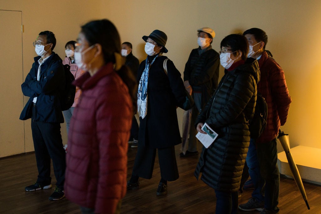 Visitors wearing protective masks watch a video clip in Shanghai Museum on March 13, 2020 in Shanghai, China. Photo: Yifan Ding/Getty Images.