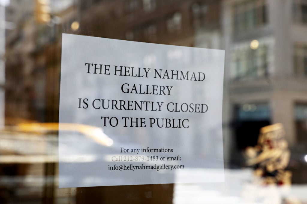 A sign is seen in the window of Helly Nahmad Gallery on Madison Avenue on March 13, 2020 in New York City. Photo by Cindy Ord/Getty Images.
