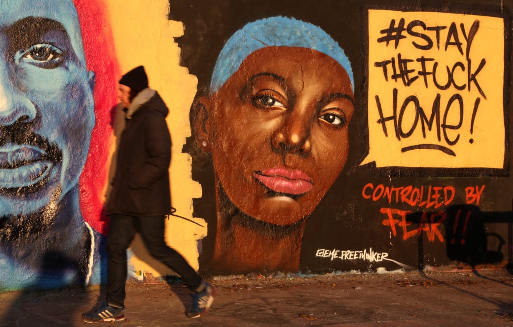Graffiti reminding people to not leave their homes, using the popular social media hashtag #staythefuckhome, is seen during the coronavirus pandemic crisis on March 23, 2020 in Berlin, Germany. Photo by Adam Berry/Getty Images.