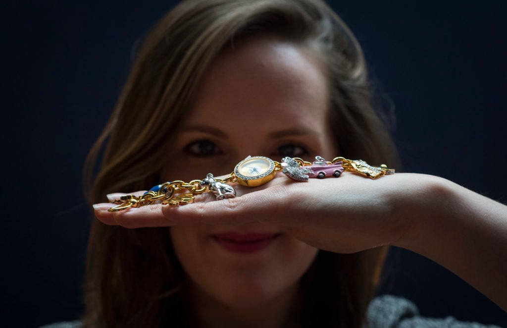 Sotheby's employee holds an Elvis themed watch bought in Graceland which is part of The Duchess collection of Elvis Presley. Photo by Justin Setterfield/Getty Images.