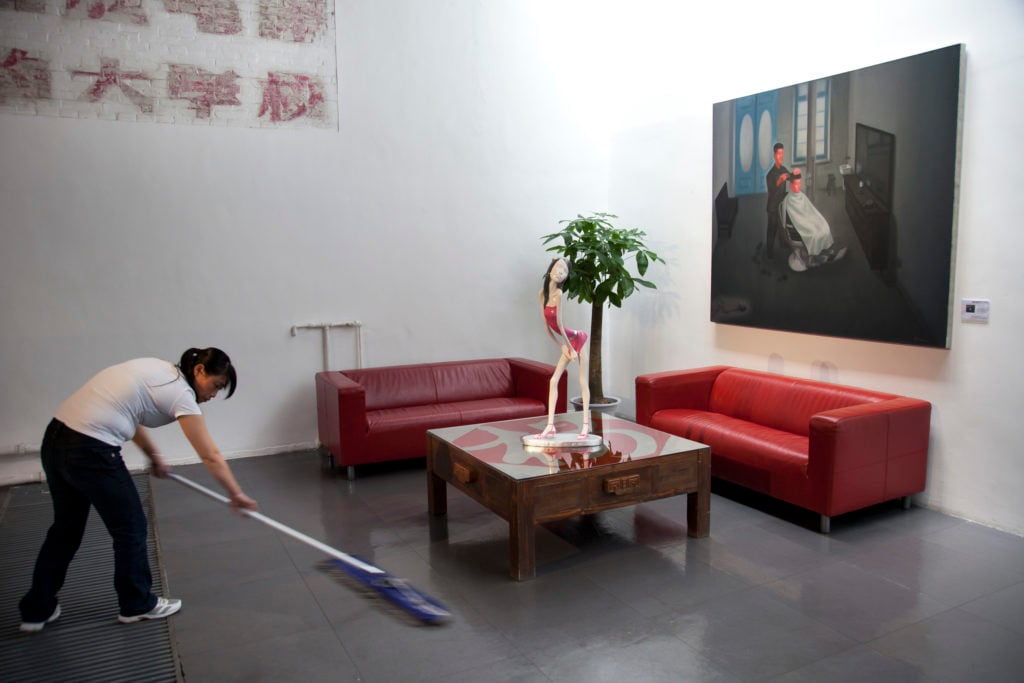 A cleaner washing the floor at 798 Art Zone or Dashanzi Art District in Beijing. Photo by In Pictures Ltd./Corbis via Getty Images.