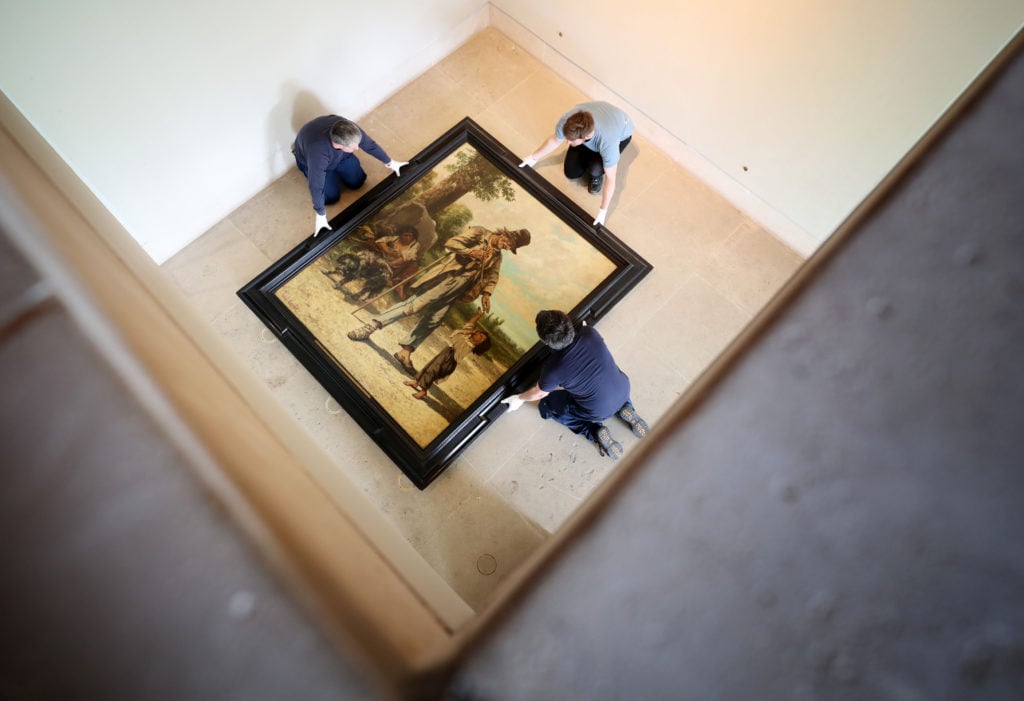 Art handlers move a work by Gustave Courbet at the Burrell Collection, Glasgow. Photo by Jane Barlow/PA Images via Getty Images.