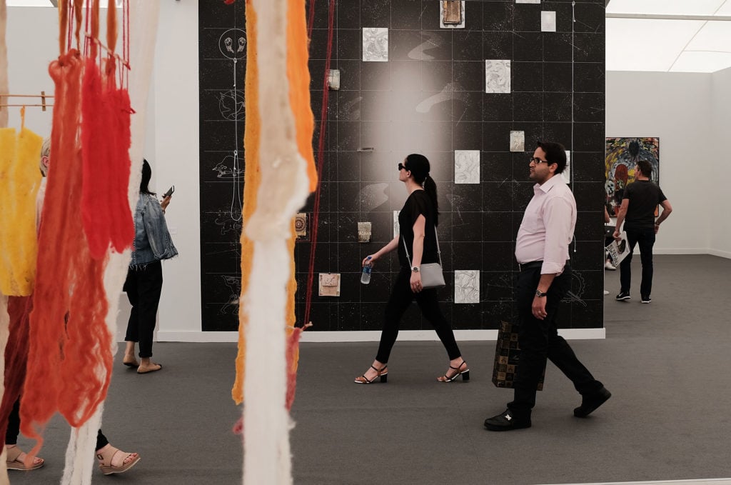 People walk through exhibits at the New York Frieze Art Fair. Photo by Spencer Platt/Getty Images.