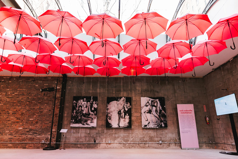 Sun Kims red umbrella installation at Sex Worker Pop-Up. Photo by Jonna Algarin Mojica courtesy of Sex Worker Pop-Up.