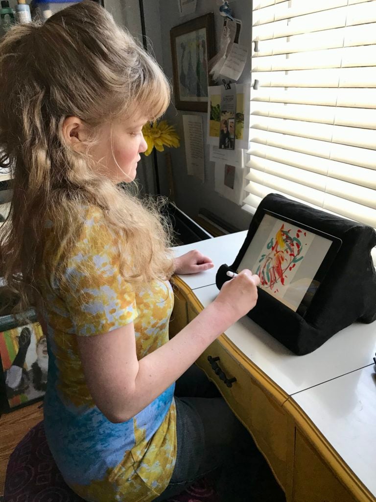 Sydney Edmond creating art on her iPad. Photo courtesy of the artist.