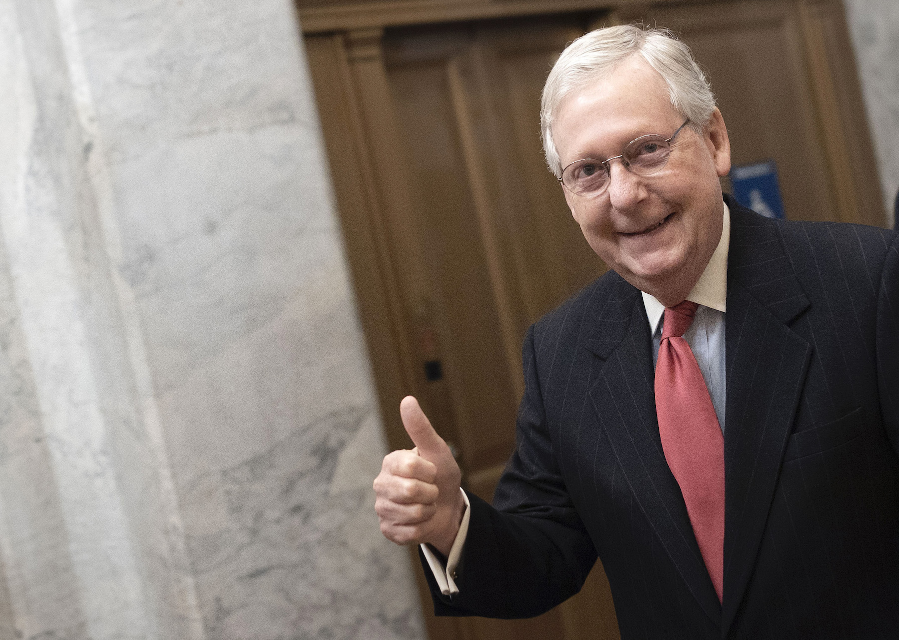 Senate Majority Leader Mitch McConnell gives a thumbs up sign as he arrives at the Capitol on March 25, 2020 in Washington, DC. Photo by Win McNamee/Getty Images.