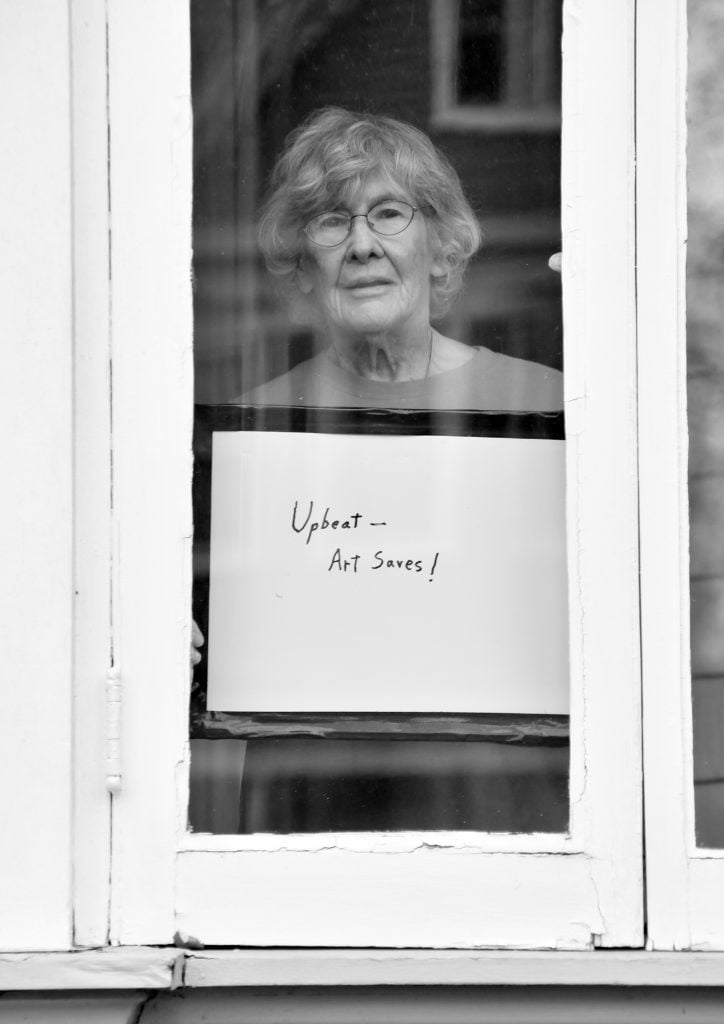 Artist Shirley Fuerst poses for "Words at the Window: Self Isolation and The Coronavirus," a portrait series by Shutterstock staff photographer, Stephen Lovekin, shot around the Ditmas Park neighborhood of Brooklyn, New York. Photo courtesy of Shutterstock.