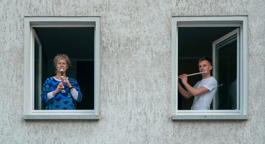 Musicians and singers in Germany try to make the emotional situation easier and to convey a feeling of togetherness. (Photo by Peter Endig/picture alliance via Getty Images)