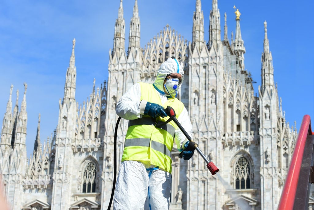 A worker sanitizes the Piazza del Duomo in Milan, Italy. (Photo by Pier Marco Tacca/Getty Images)