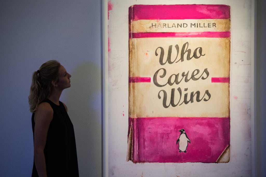 Who Cares Wins by Harland Miller at Sotheby's Art for Grenfell press preview on October 12, 2017, in London. The artist has released a similar print with White Cube to benefit relief efforts. (Photo by Chris J Ratcliffe/Getty Images for Sotheby's)