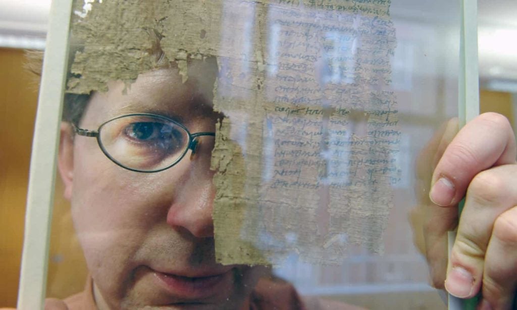 Dirk Obbink working on a papyrus at the Sackler Institute at Oxford University. Photo by Geraint Lewis/Oxford University. 