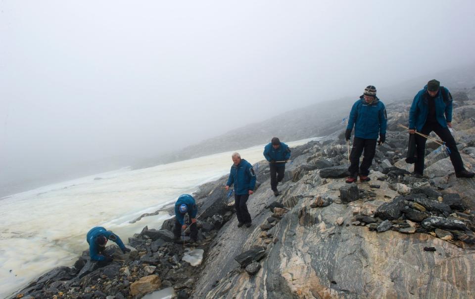Members of the Secrets of the Ice team surveying the Lendbreen pass. Photo by Johan Wildhagen, Palookaville.