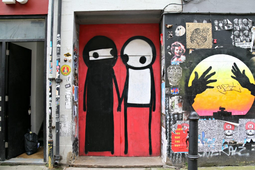 Stik's "Couple Holding Hands" is one of the few street art murals is continually maintained in the ever changing Shoreditch street art scene.