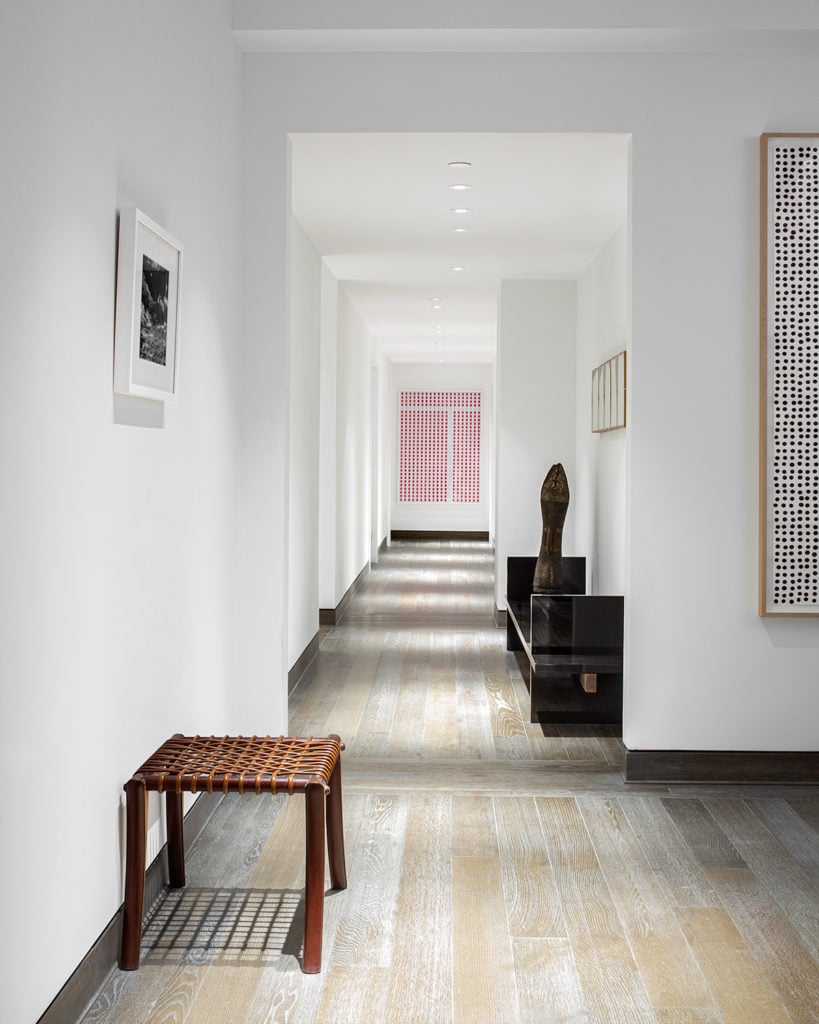 The hallway featuring works by Marco Maggi and a 19th century Elema sculpture from Papua New Guinea. Photo courtesy 111 West 57th Street.