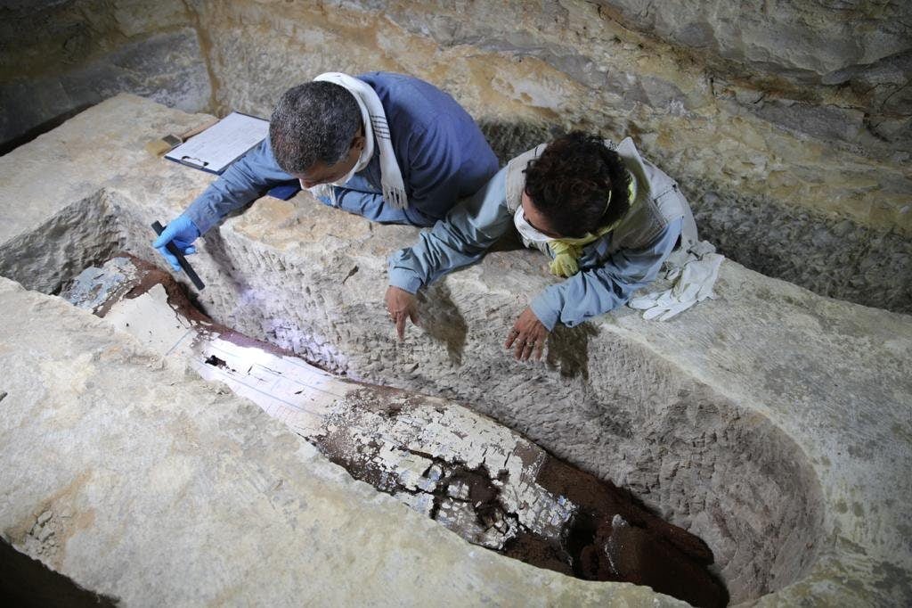 Egyptologist Ramadan Hussein (left) and mummy specialist Salima Ikram examine a limestone sarcophagus weighing over seven tons at the mummification workshop in Saqqara. Photo courtesy of the Egypt Ministry of Tourism and Antiquities.