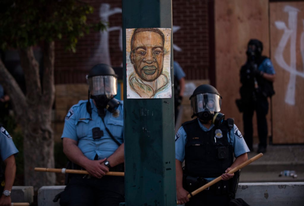 A portrait of George Floyd hangs on a street light pole in Minneapolis, Minnesota. Photo by Stephen Maturen/Getty Images.