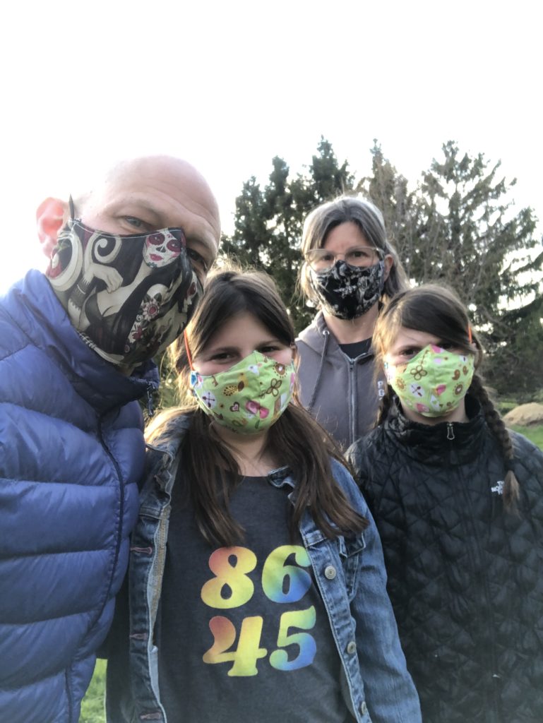 Ken Sager, Beth Lipman, and their children making their homemade masks. Photo courtesy of the artists. 
