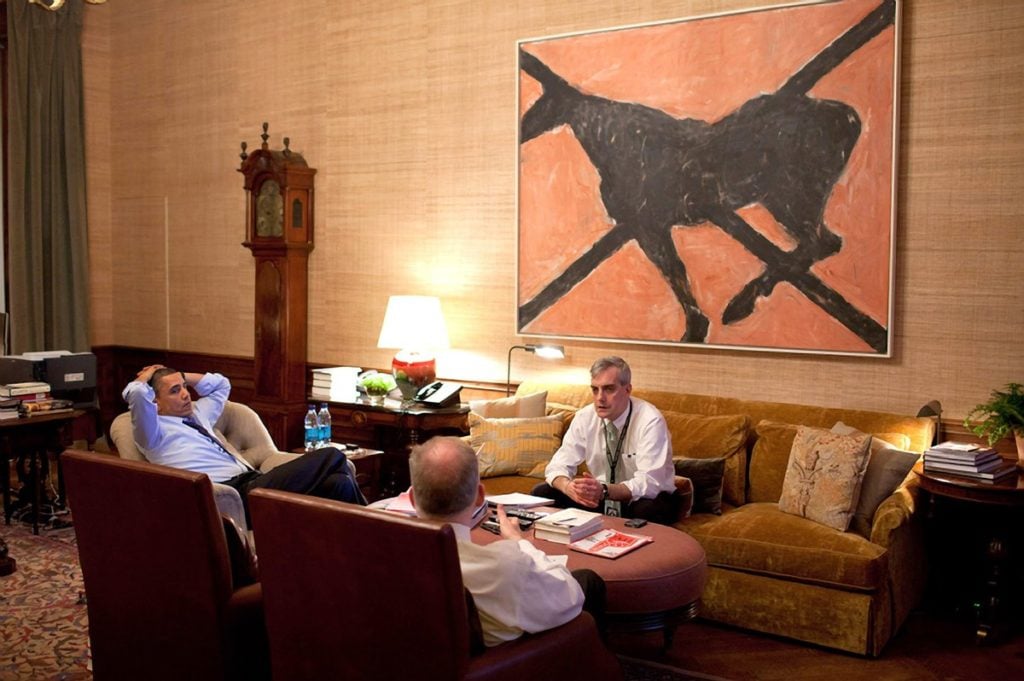 President Obama meets with national security aides John Brennan, foreground, and Denis McDonough in front of Susan Rothenberg's <em>Butterfly</em>, from the collection of the National Gallery of Art. Photo by Pete Souza for the White House.
