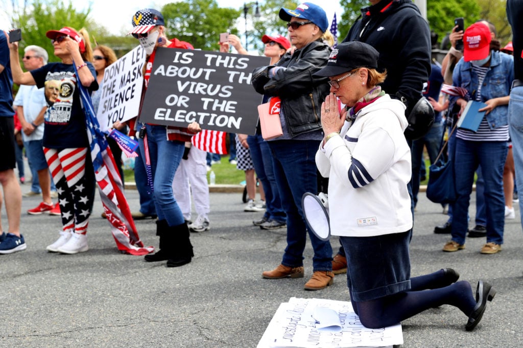 Protestors pray near Governor Charlie Baker's residence during a Reopen Massachusetts Rally on May 16, 2020 in Boston, Massachusetts. Photo by Maddie Meyer/Getty Images.