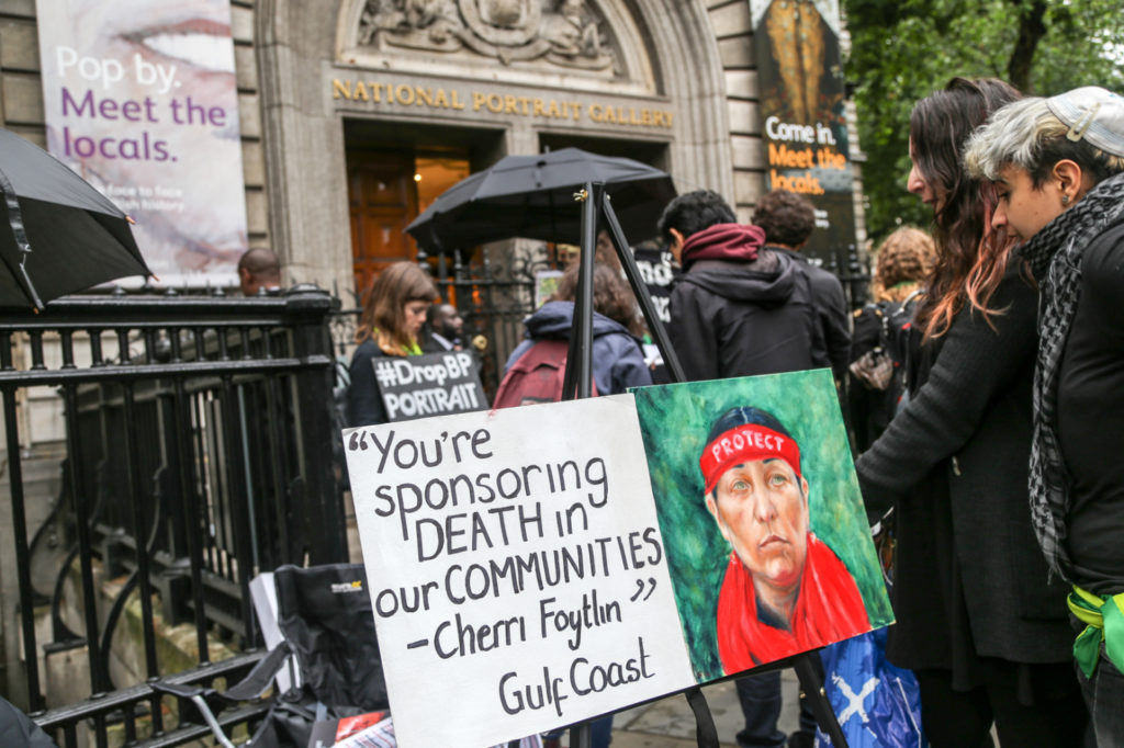 Zora Owen painted a portrait of Cherri Foytlin, Indigenous journalist and advocate against BP’s catastrophic Deepwater Horizon disaster in 2010, outside the National Portrait Gallery in London protesting the 2019 BP Portrait Award ceremony. Photo by Diana More, courtesy of BP or Not BP?.