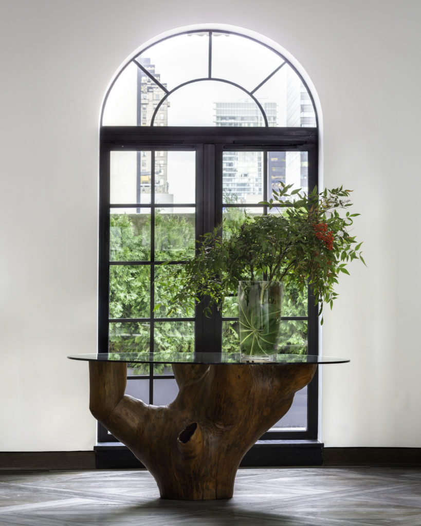 A 1980s Denuncia table by José Zanine Caldas displayed in front of a window in the main room. Photo courtesy 111 West 57th Street.