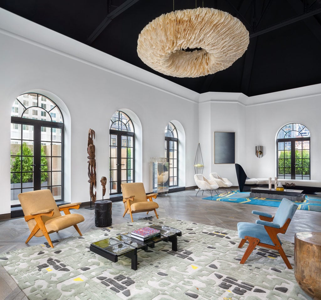 A view of the art-filled penthouse living room at 111 West 57th Street.
