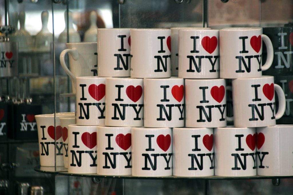 Mugs with Milton Glaser's <em>I ♥ NY</em> logo are offered for sale in a souvenir shop. Photo by Christina Horsten/picture alliance/dpa/Getty Images.