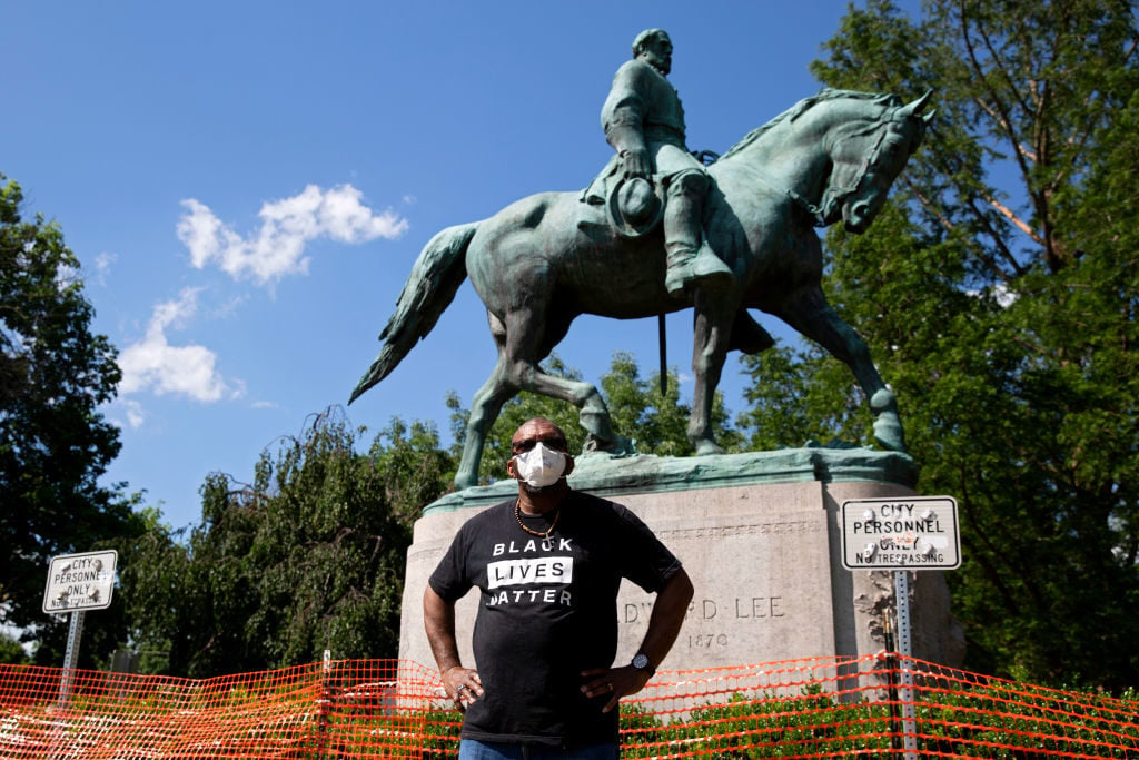 Don Gathers stands in front of a statue depicting Robert E. Lee during a racial justice protest in Charlottesville on May 30, 2020. Photo by Ryan M. Kelly / AFP via Getty Images.