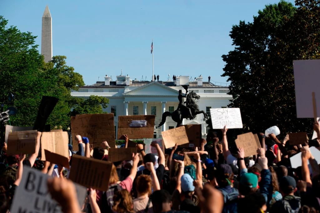 Demonstrators hold up placards protest outside of the White House, over the death of George Floyd in Washington D.C. on June 1, 2020.(Photo by JOSE LUIS MAGANA/AFP via Getty Images)