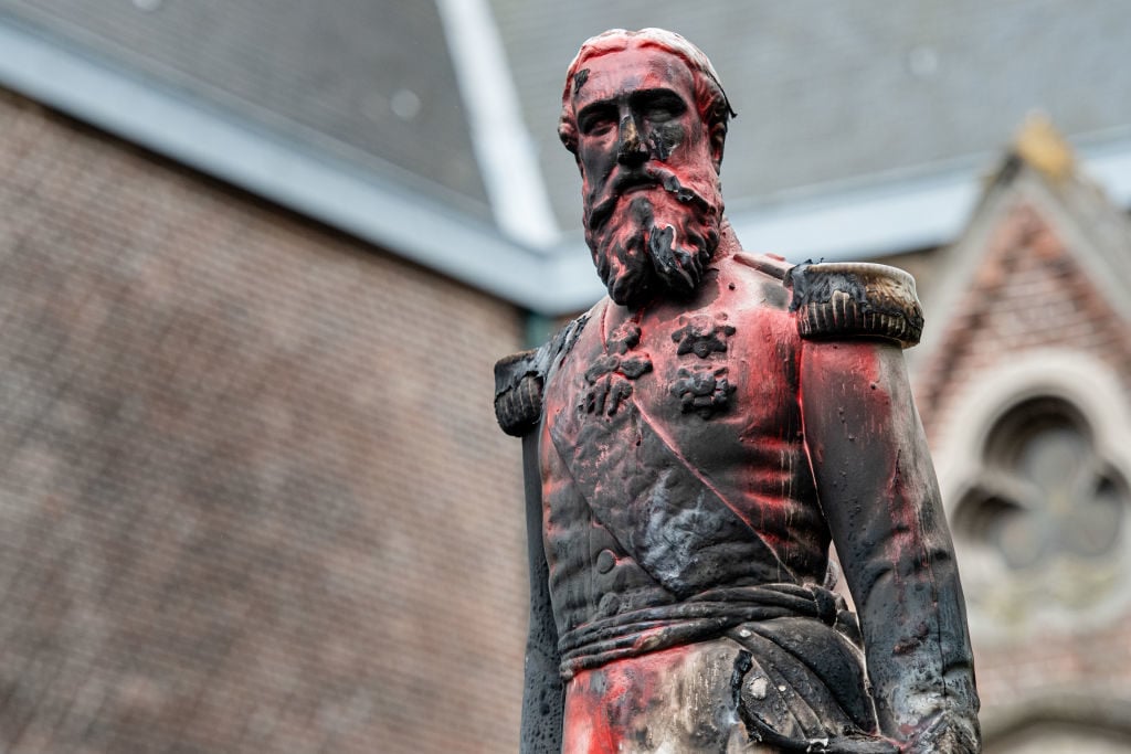 A statue of King Leopold II of Belgium is pictured on June 4, 2020 in Antwerp after being set on fire the night before. Photo by Jonas Roosens/Belga/AFP via Getty Images.