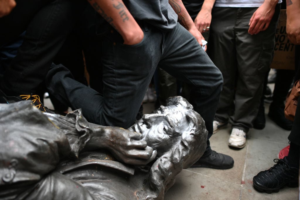 Protesters pull down a statue of Edward Colston during a Black Lives Matter protest rally in Bristol. Photo by Ben Birchall/PA Images via Getty Images.