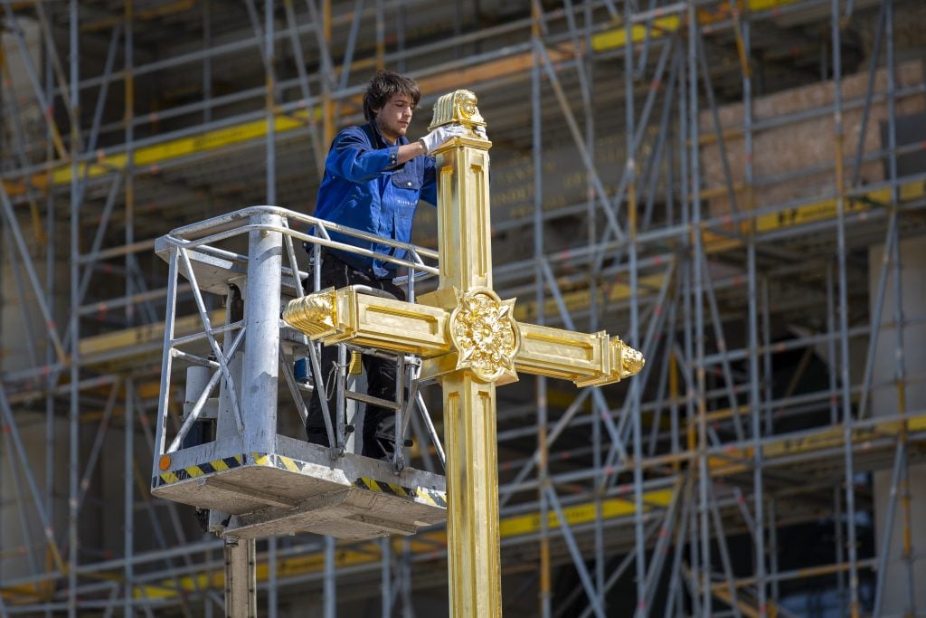Peter Durku, metal designer, works on the cross on the lantern for the dome of the Berlin City Palace that will anoint the rebuilt Berlin City Palace. Photo: Maja Hitij/Getty Images.