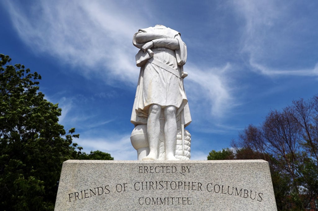 A statue depicting Christopher Columbus is seen with its head removed at Christopher Columbus Waterfront Park on June 10, 2020 in Boston, Massachusetts. Photo: Tim Bradbury/Getty Images.