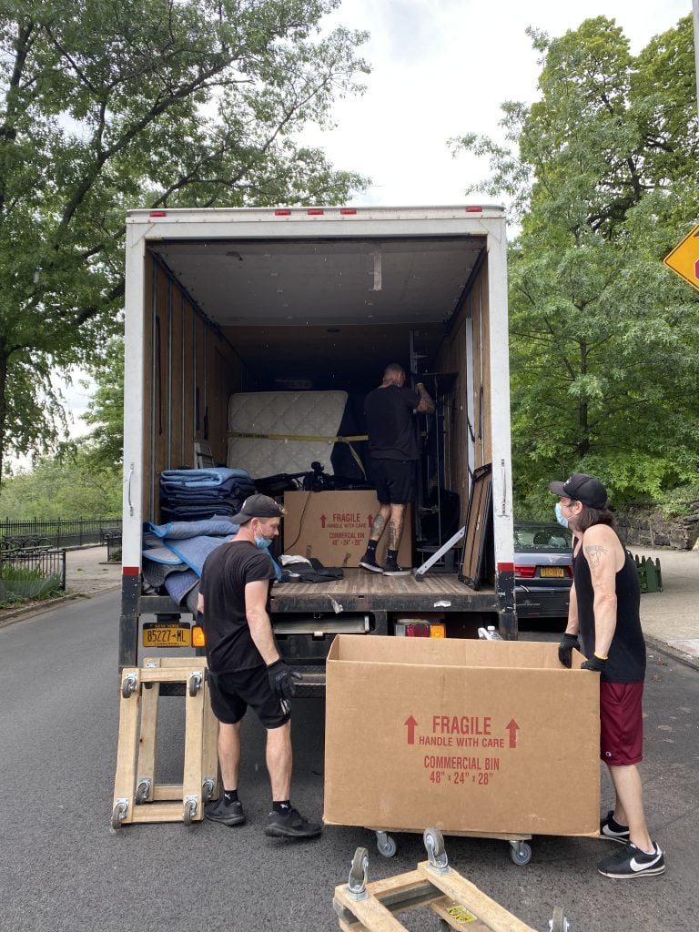Joey Rosado on the Sven's Moving truck with two of his coworkers. Photo by Sarah Cascone.