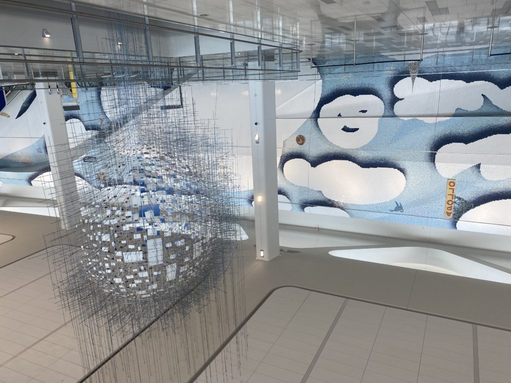 Sarah Sze's <em>Shorter than the Day</em> (2020), in front of Laura Owens's <em>I [pizza emoji] NY</em> (2020) at LaGuardia Airport. Commissioned by LaGuardia Gateway Partners in partnership with Public Art Fund for LaGuardia Airport’s Terminal B. Photo by Sarah Cascone.