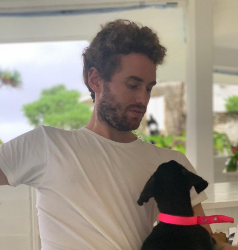 Inigo Philbrick on the island of Vanuatu with one of the dogs he rescued.
