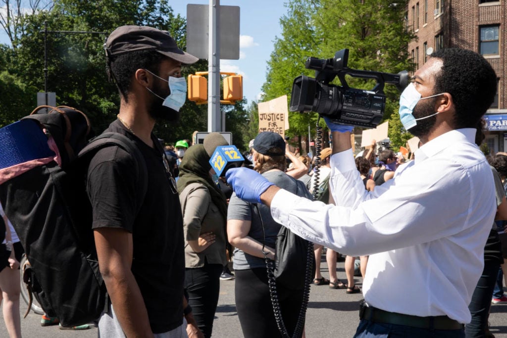 A protestor being interviewed in Flatbush. Image courtesy Ventiko.