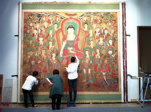 Conservators working on the Yeongsanhoesangdoat LACMA in March 2012. Courtesy of LACMA.