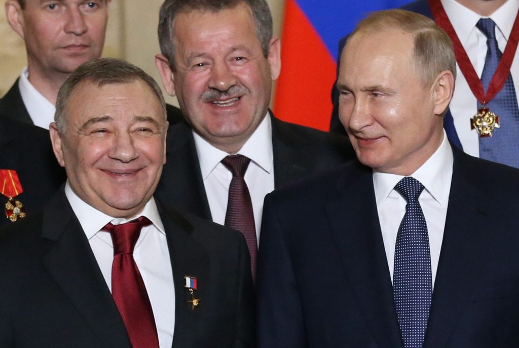 Russian president Vladimir Putin (right) looks on billionaire and businessman Arkady Rotenberg during an awards ceremony at the museum in Sevastopol, Crimea, Ukraine, March,18, 2020. Photo by Mikhail Svetlov/Getty Images.