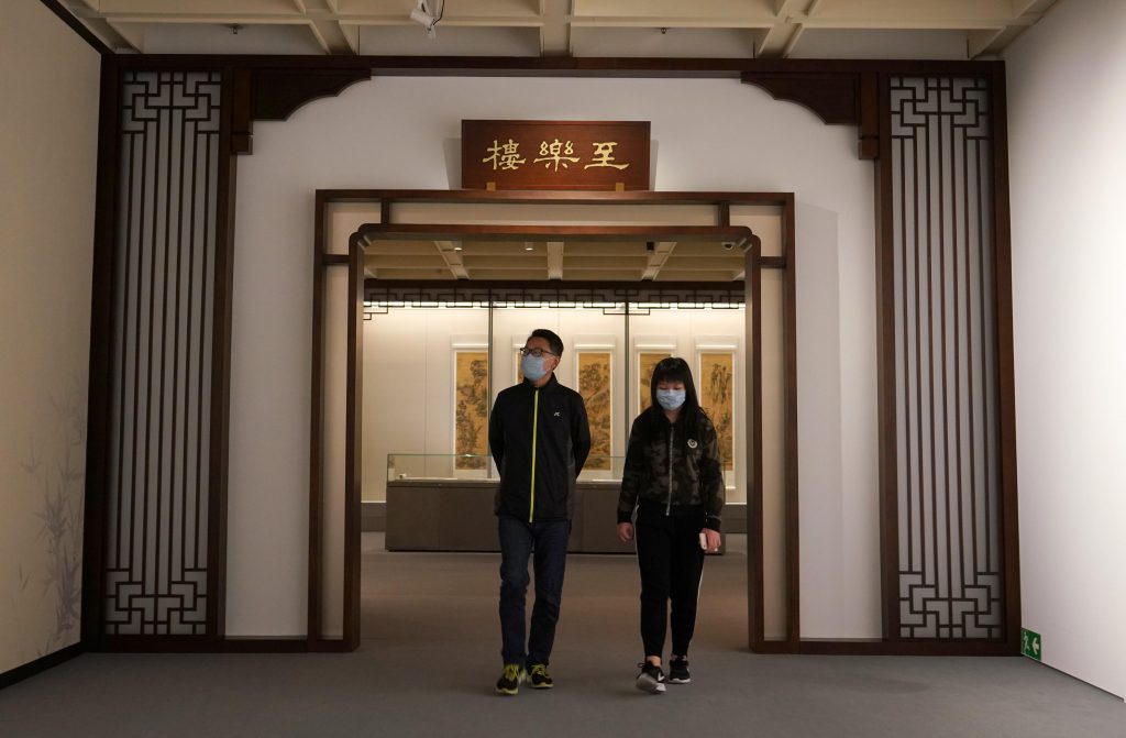 People wearing face masks visit the "The Chih Lo Lou Collection of Chinese Painting and Calligraphy" collection exhibition at Hong Kong Museum of Art on March 11, 2020 in Hong Kong, China. Photo by Zhang Wei/China News Service/Getty Images.