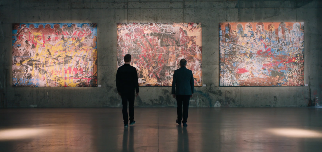 Bobbly Axelrod and Mike Wagner take in three works of Nico Tanner's "Implosion" series on <em>Billions</em>. Courtesy of Showtime. 
