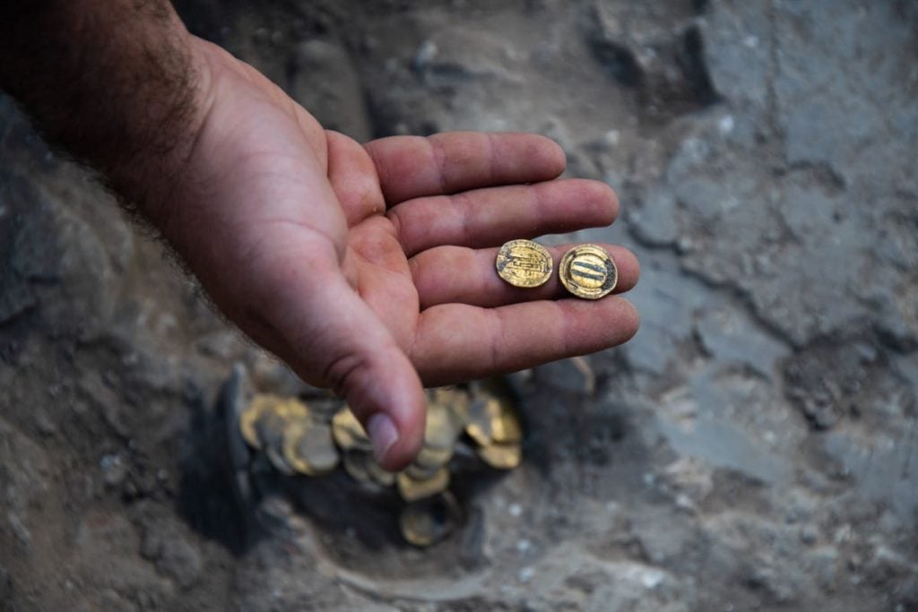 A cache of ancient golden coins was found buried in a clay jar in Israel. Photo by Yoli Shwartz, courtesy of the Israel Antiquities Authority.