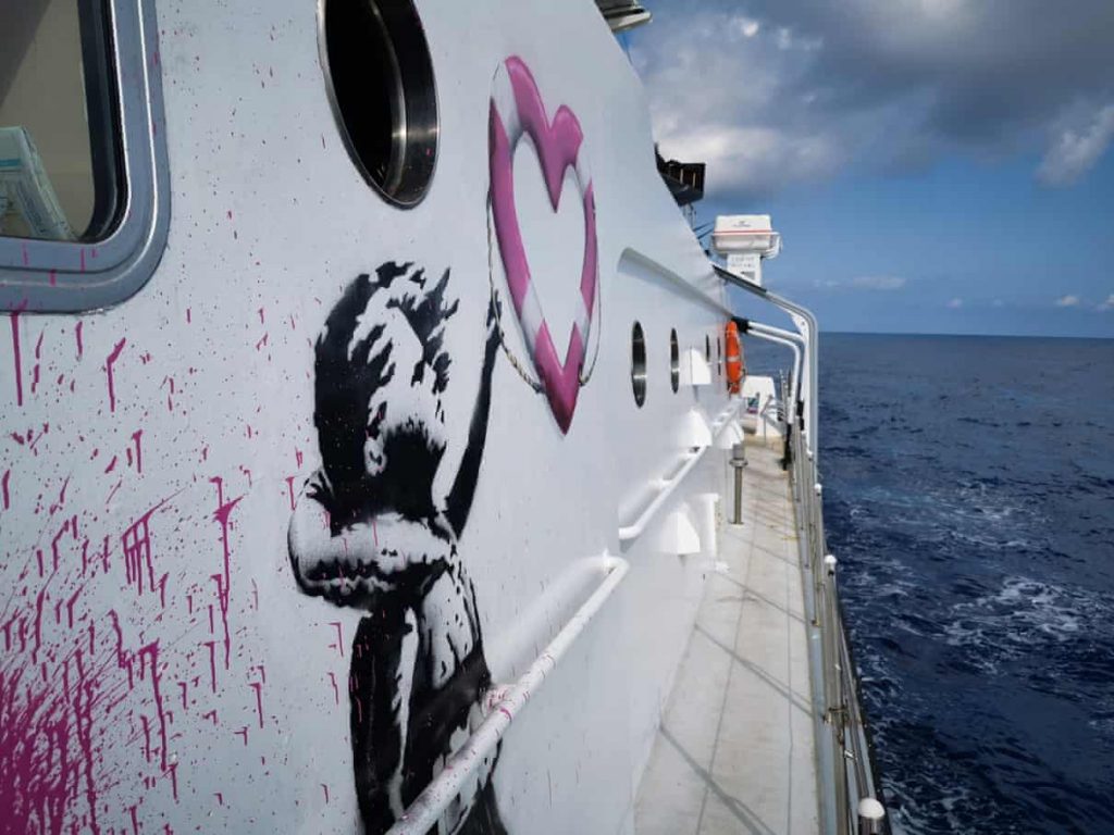 Banksy's artwork on the <em>Louise Michel</em>, a rescue vessel for refugees in the Mediterranean. Photo by Ruben Neugebauer/Sea-Watch. 