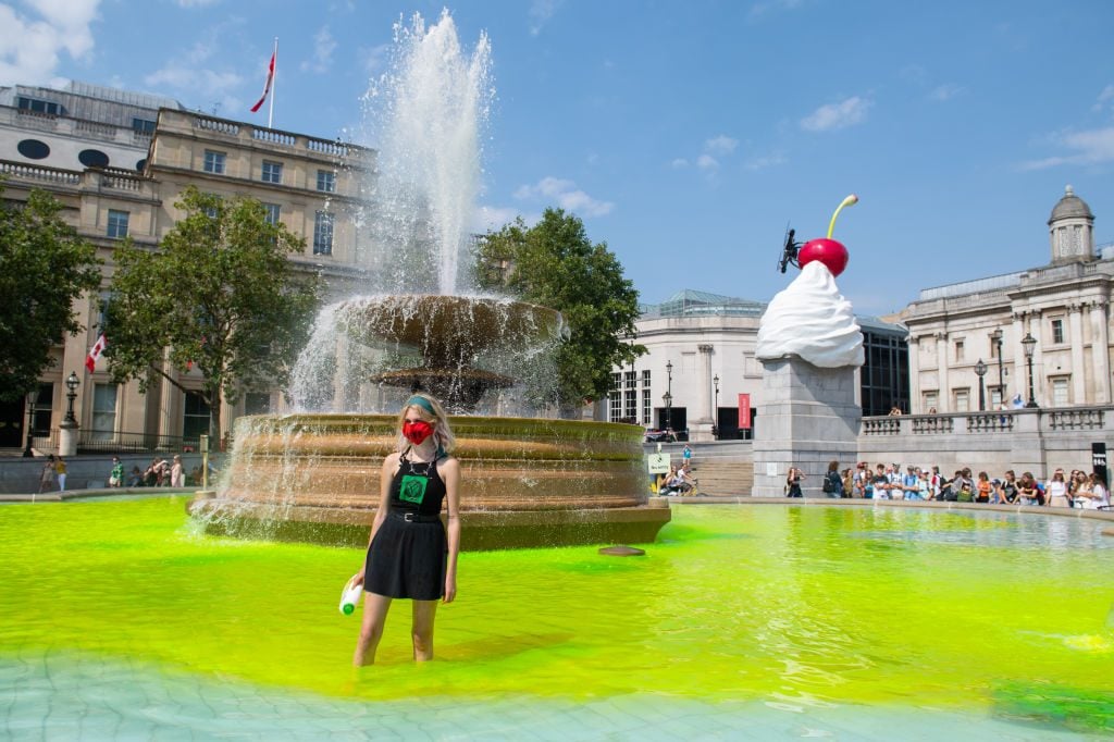 Extinction Rebellion activists dye fountains in Trafalgar Square, London, during a protest in solidarity with indigenous communities in Brazil who are dying from Covid-19. Photo by Dominic Lipinski/PA Images via Getty Images.