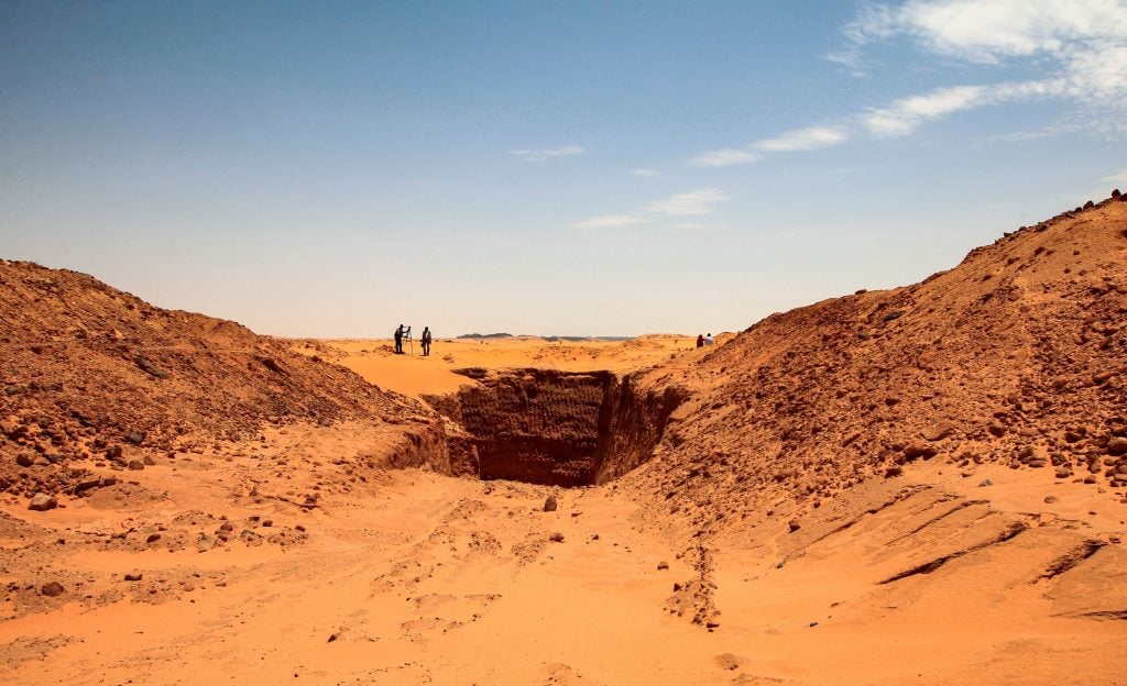A vast trench dug by gold hunters is pictured at the devastated two millenia-old site of Jabal Maragha. Photo by Ebrahim Hamid/AFP/Getty Images.